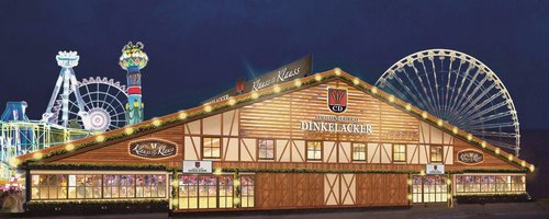 Das Dinkelacker-Festzelt von Klauss und Klauss von außen bei Dunkelheit