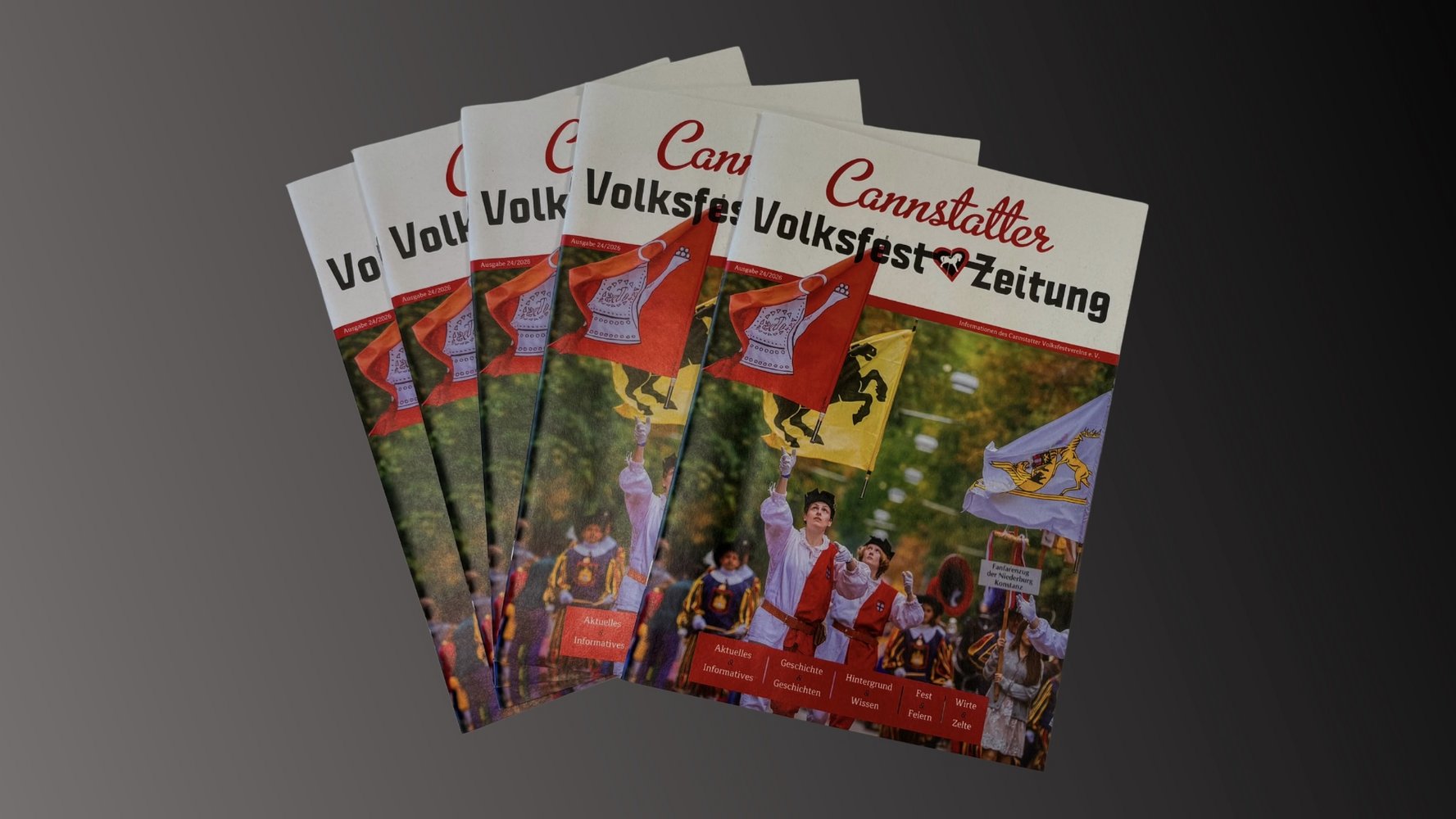 Vier aktuelle Ausgaben der Volksfestzeitung aufgefächert.