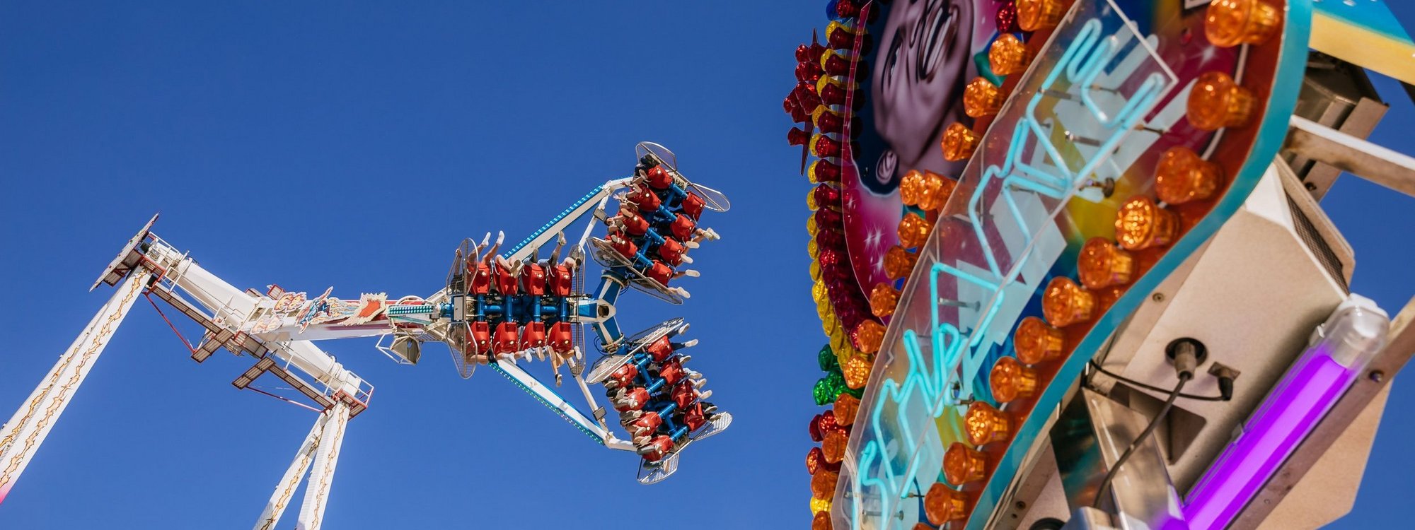 On the left is a swivel arm, on the right a sign that says ‘Shake’ against a blue sky.